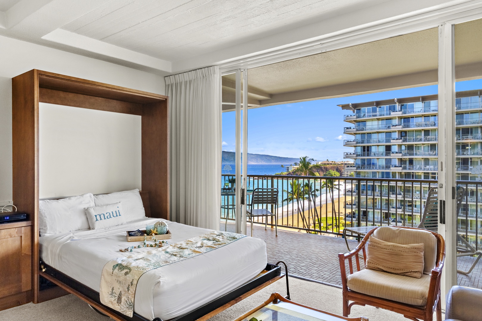 Space-saving Murphy bed seamlessly integrated into the living area, offering comfort and flexibility with direct balcony access and scenic views.
