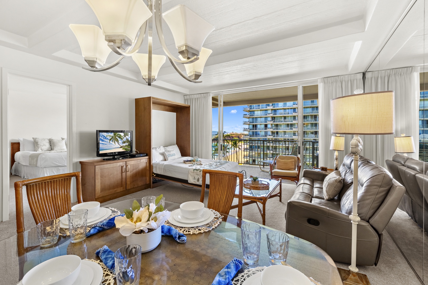 Inviting living space with comfortable seating, a dining setup nearby, and large windows that fill the room with natural light.