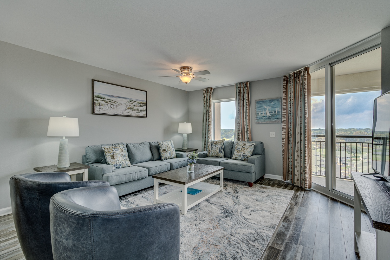 Unwind in your spacious living room with plush sectional seating and natural light streaming through sliding doors to your private balcony.