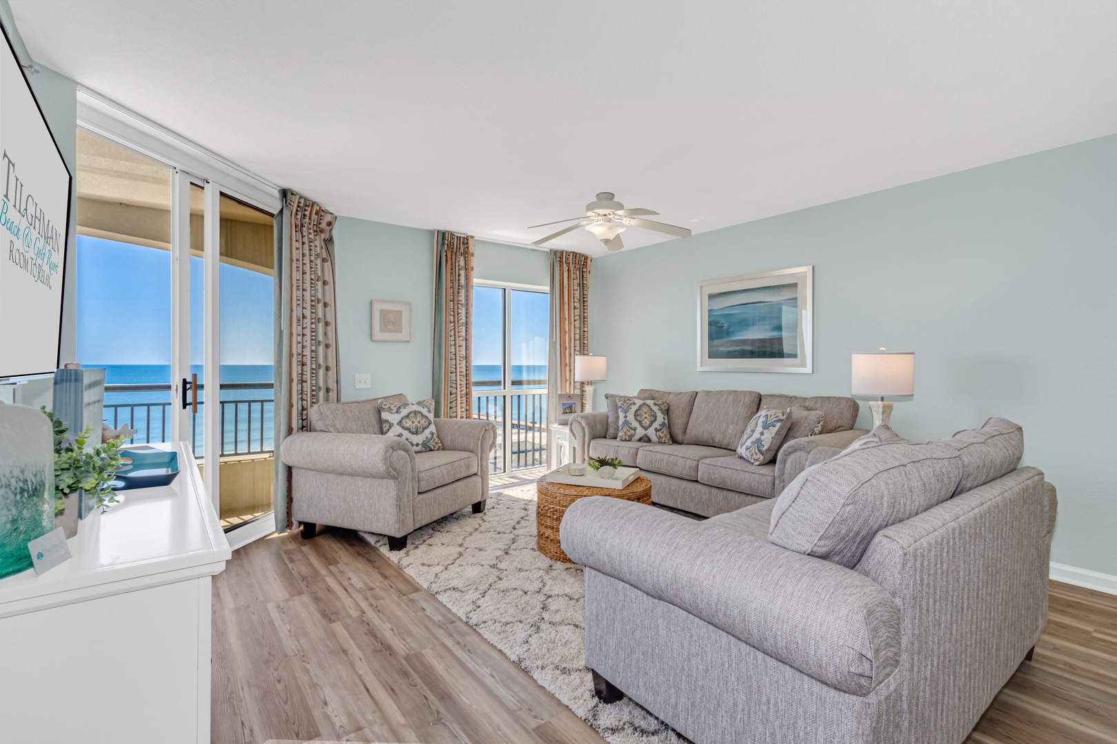 Relax in your coastal haven with plush seating and stunning ocean views through floor-to-ceiling windows.