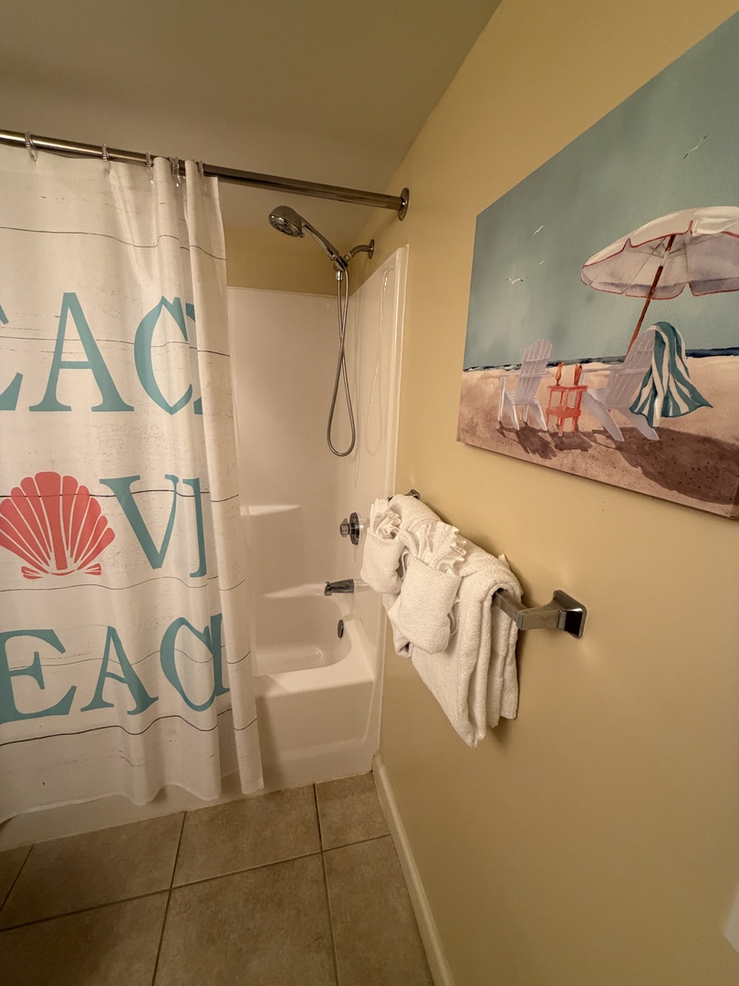 Unwind in your private bath with fresh towels and coastal-themed touches that bring seaside charm to your relaxation time.