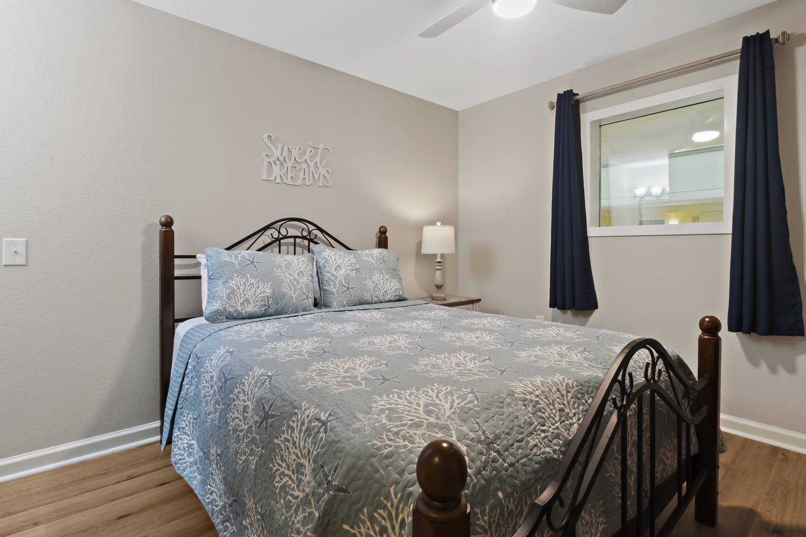 Your peaceful bedroom features a comfortable queen bed and sweet dreams wall art, perfect for restful nights.
