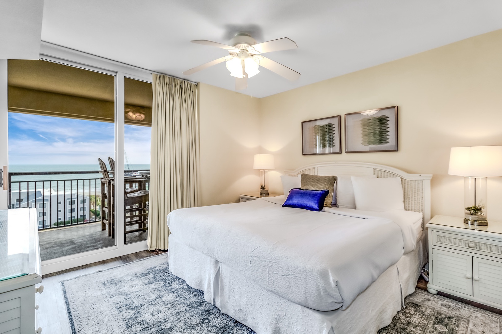 Drift off in your serene coastal bedroom with crisp linens and a private balcony overlooking stunning water views.