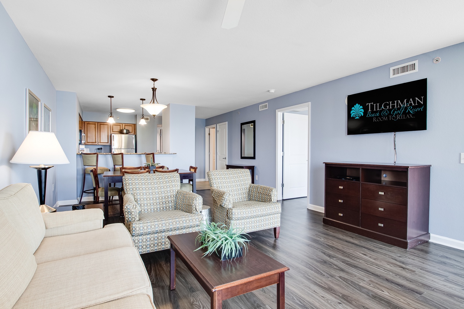 Relax in your spacious living area with comfortable seating and open kitchen, perfect for unwinding after beach adventures.