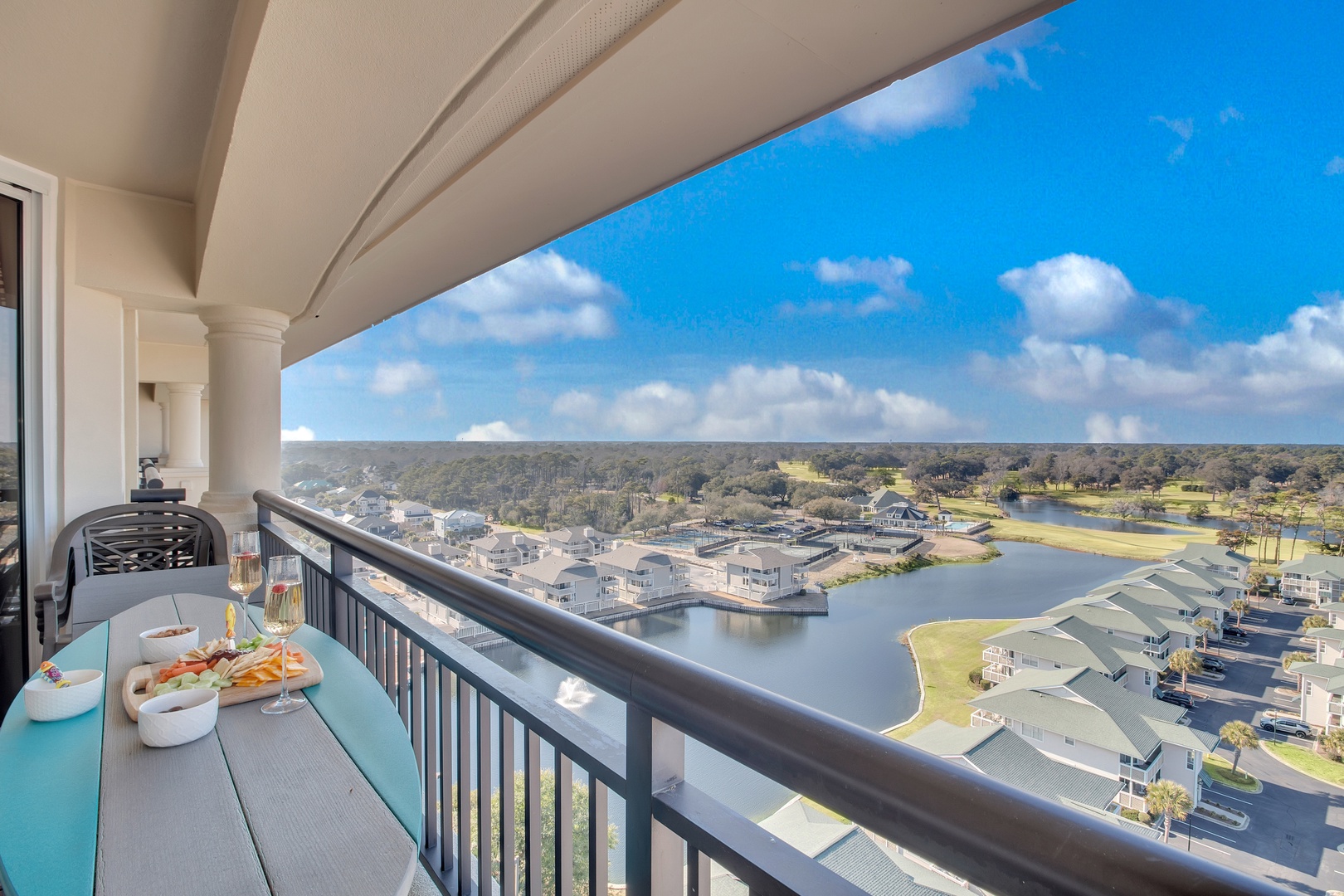 Enjoy your morning coffee on this private balcony with stunning water views, where the peaceful waterfront stretches below you.