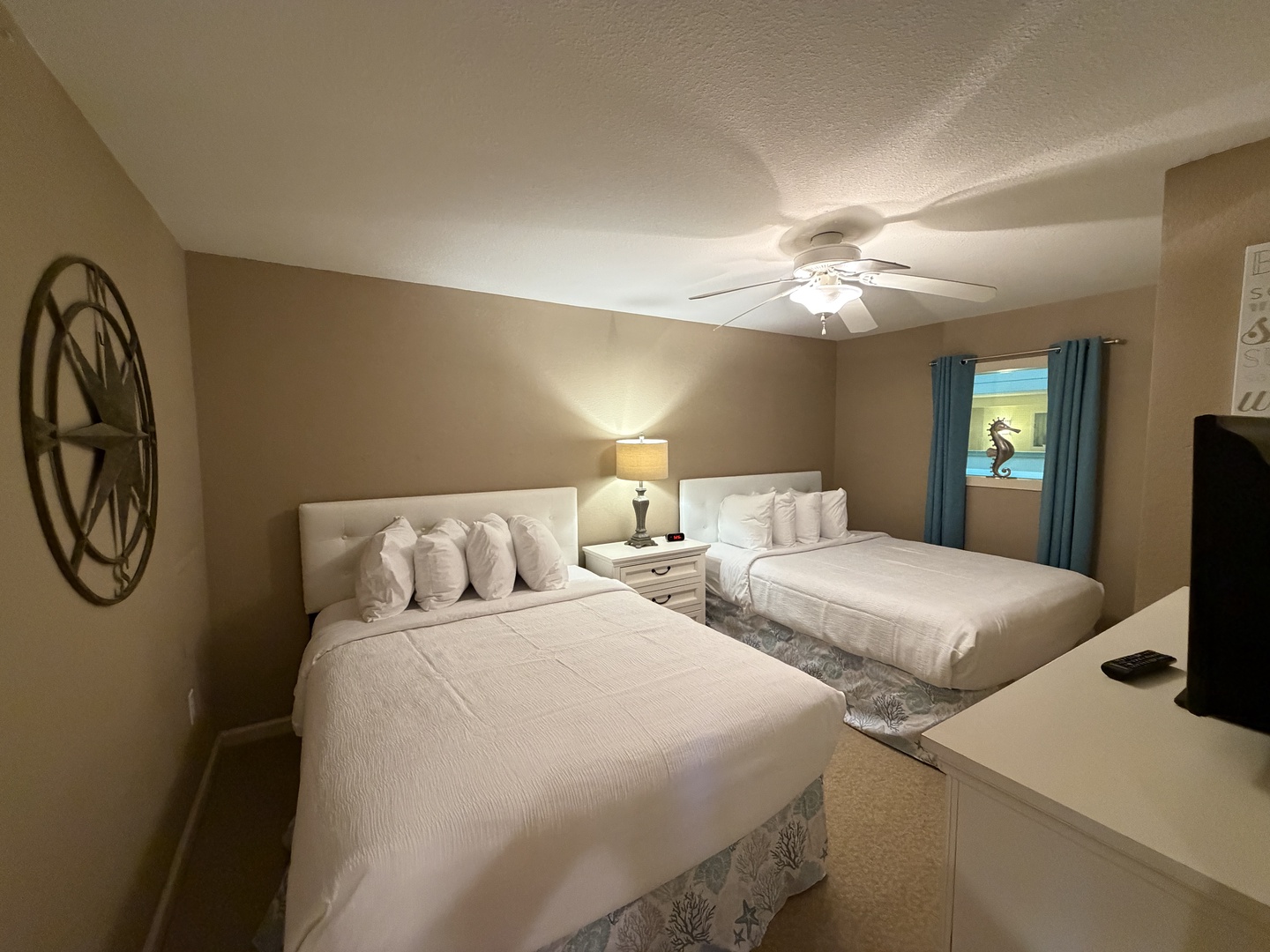 Unwind in your spacious bedroom featuring two comfortable beds with crisp linens, perfect for family stays or sharing with friends.