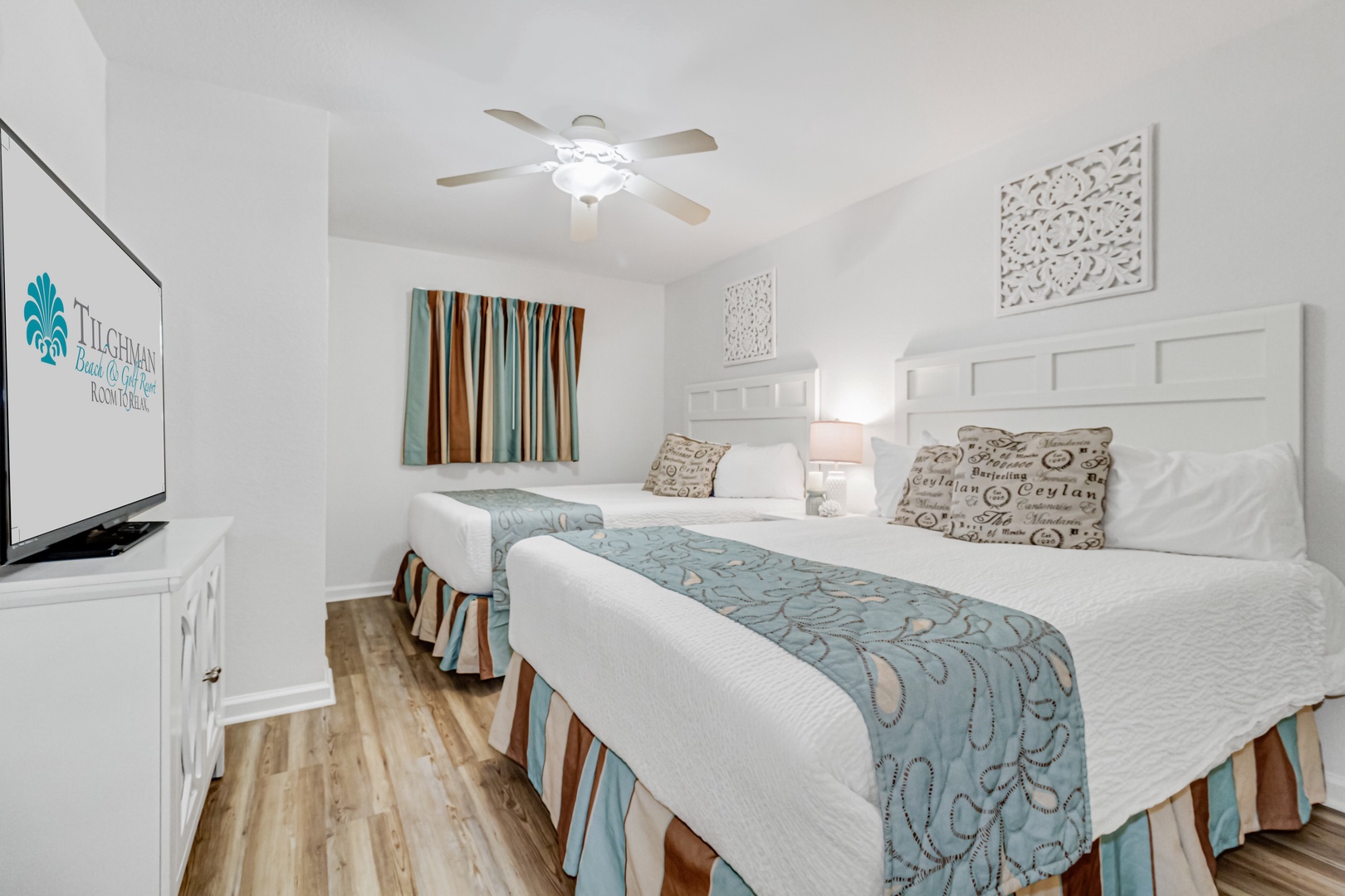 Drift off to peaceful sleep in your bright bedroom, featuring twin beds with ocean-inspired linens and coastal décor.