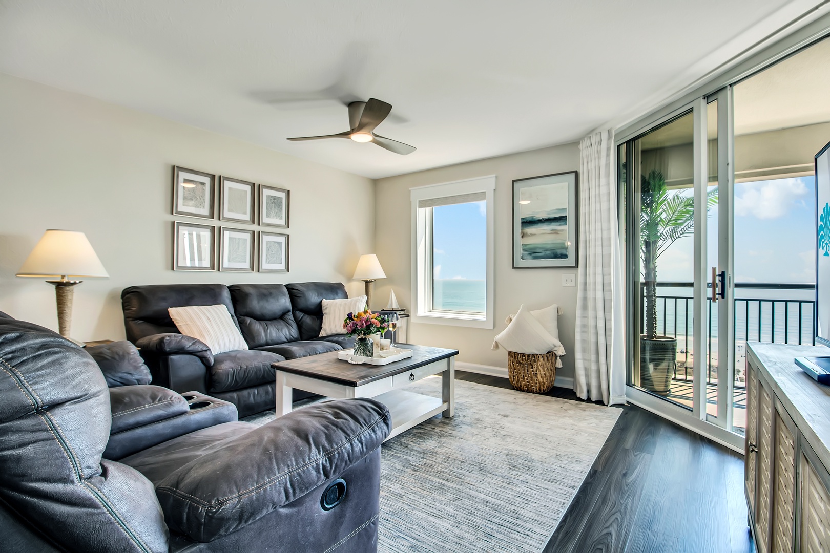 Sink into plush leather recliners and enjoy stunning ocean views from your private balcony in this beautifully appointed living room.