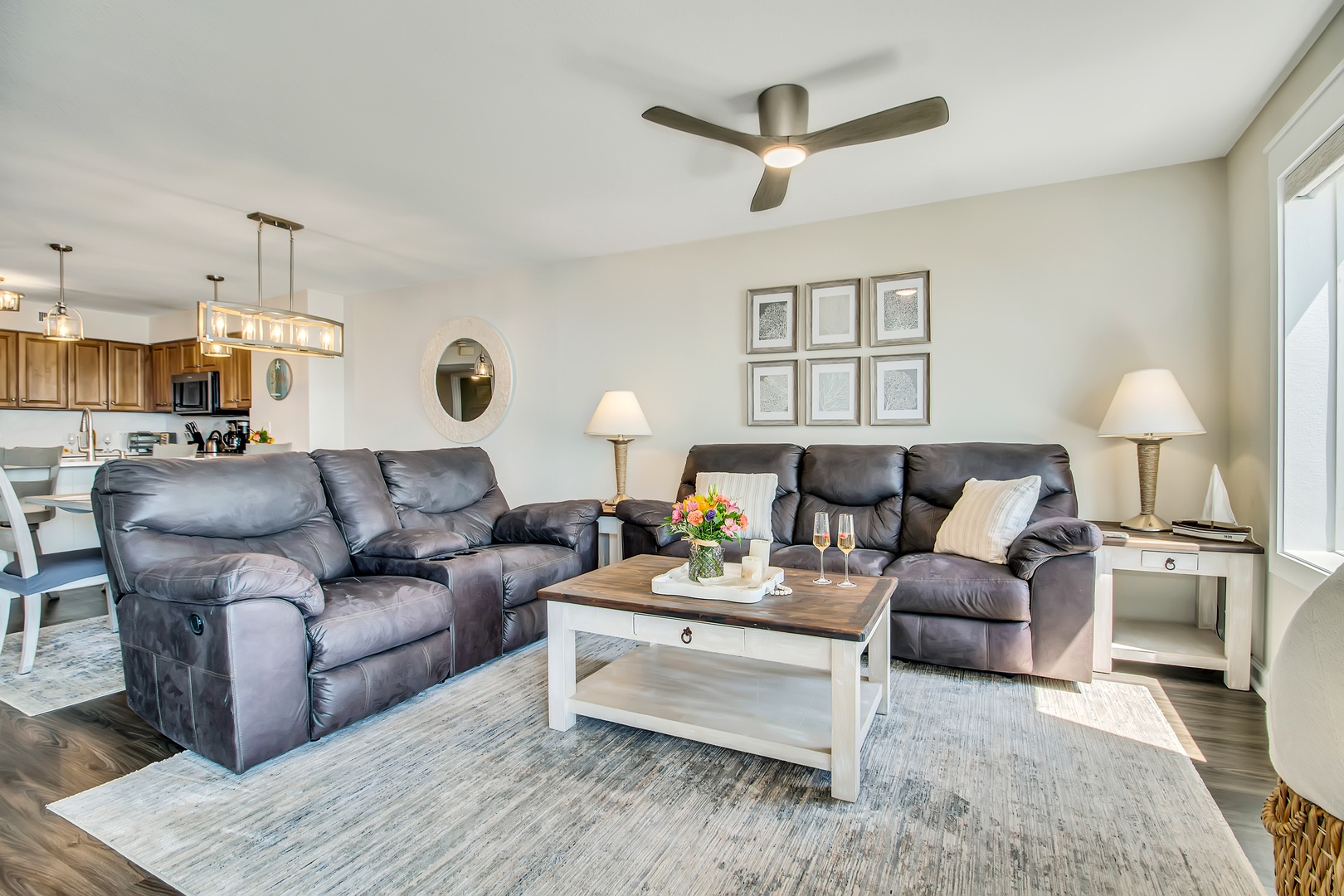 Sink into plush leather recliners in your spacious living room, where modern comfort meets coastal charm with thoughtful touches.