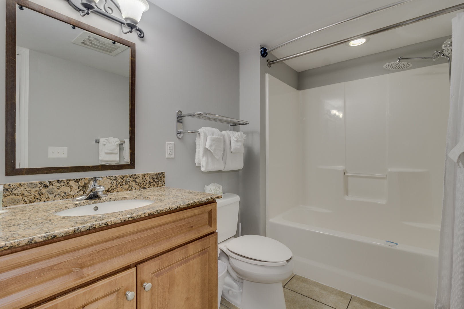 Step into your private bathroom featuring a spacious tub-shower combo and granite vanity for refreshing moments.
