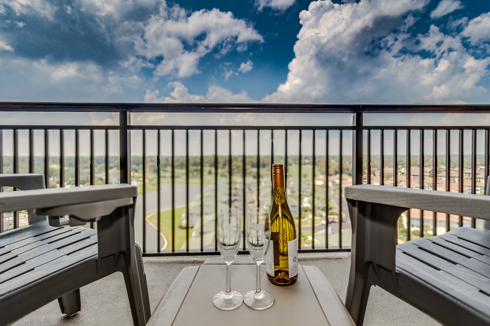 Sip wine on your private balcony while taking in sweeping city views and dramatic cloud formations above.