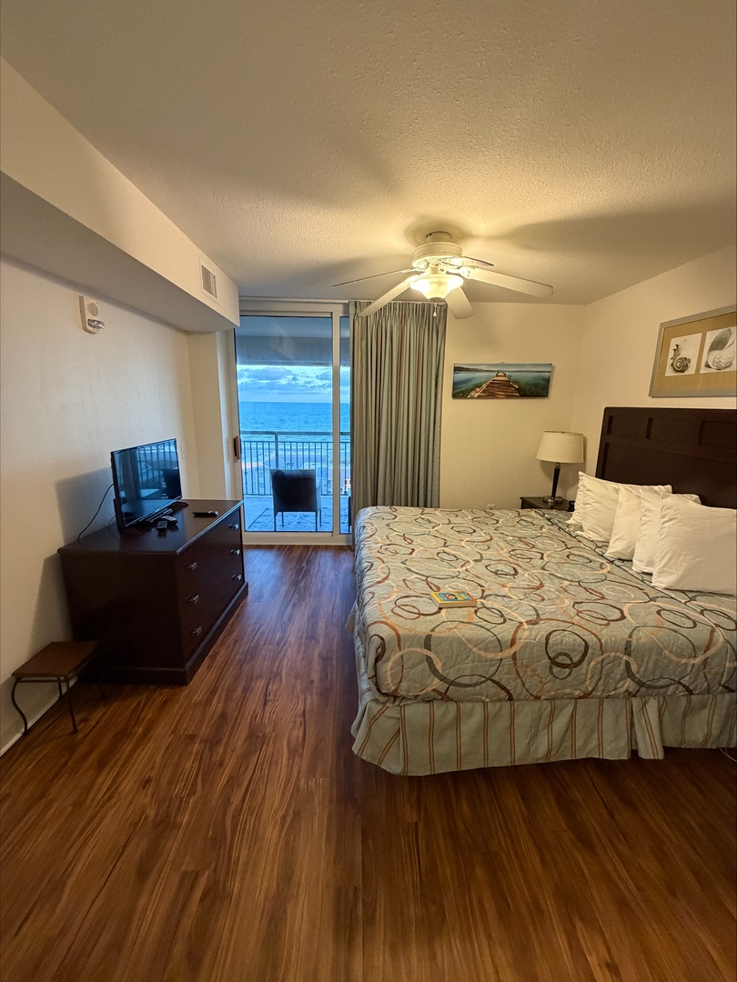 Wake up to the soothing sound of waves and step onto your private balcony to greet the ocean. Your spacious retreat features a plush king bed, rich wood floors, and a serene coastal ambiance.