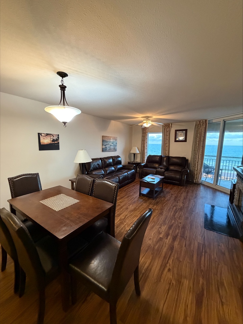 Bright, open living space with plush leather sofas and dining area. Enjoy breathtaking ocean views from your private balcony while relaxing after a day of exploration.