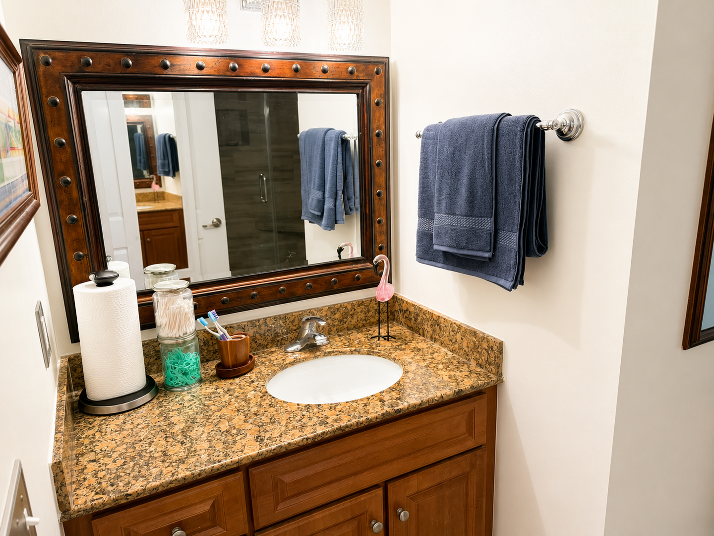 Your private bathroom features a spacious granite vanity, elegant wood cabinetry, and plush towels, all thoughtfully arranged to make your stay comfortable and convenient.