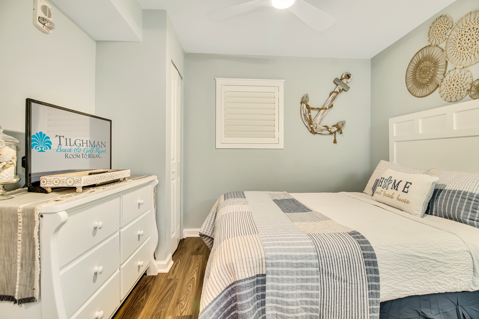 Drift off in this cozy coastal bedroom with its soothing nautical theme and crisp white linens welcoming you to peaceful sleep.