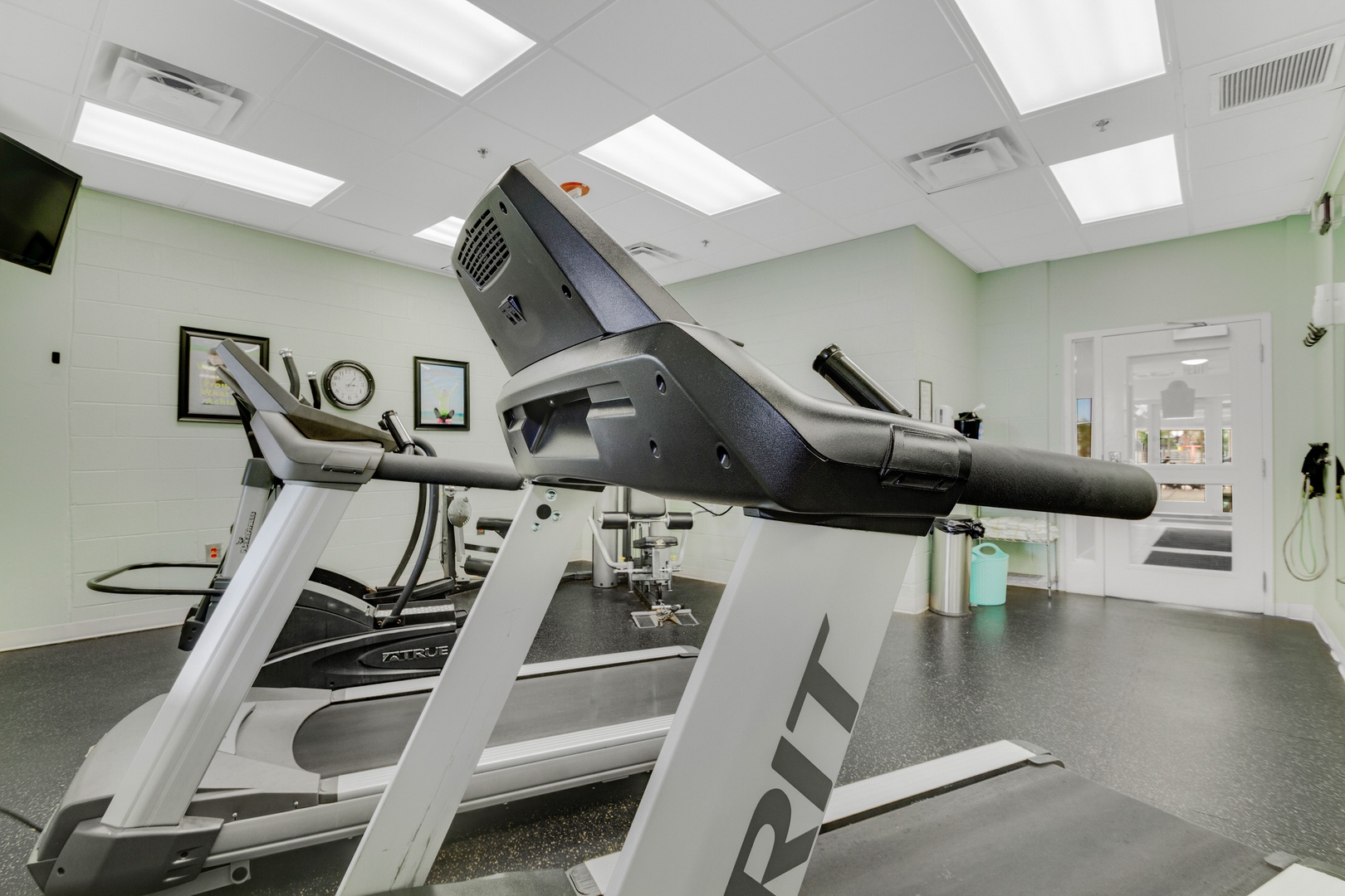 This bright, modern fitness center keeps you active and energized, featuring professional-grade equipment under natural skylights and refreshing mint-green walls.