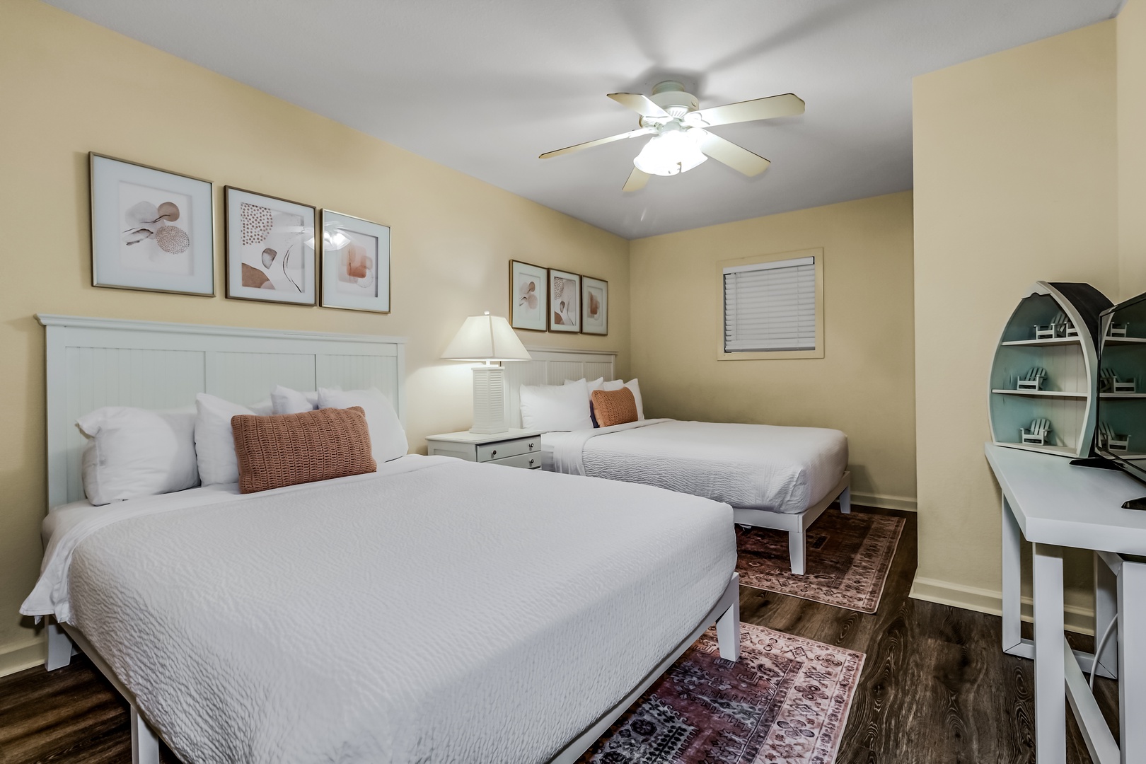 Sleep peacefully in your bright twin bedroom with crisp linens, coastal artwork, and a dedicated workspace for morning planning.