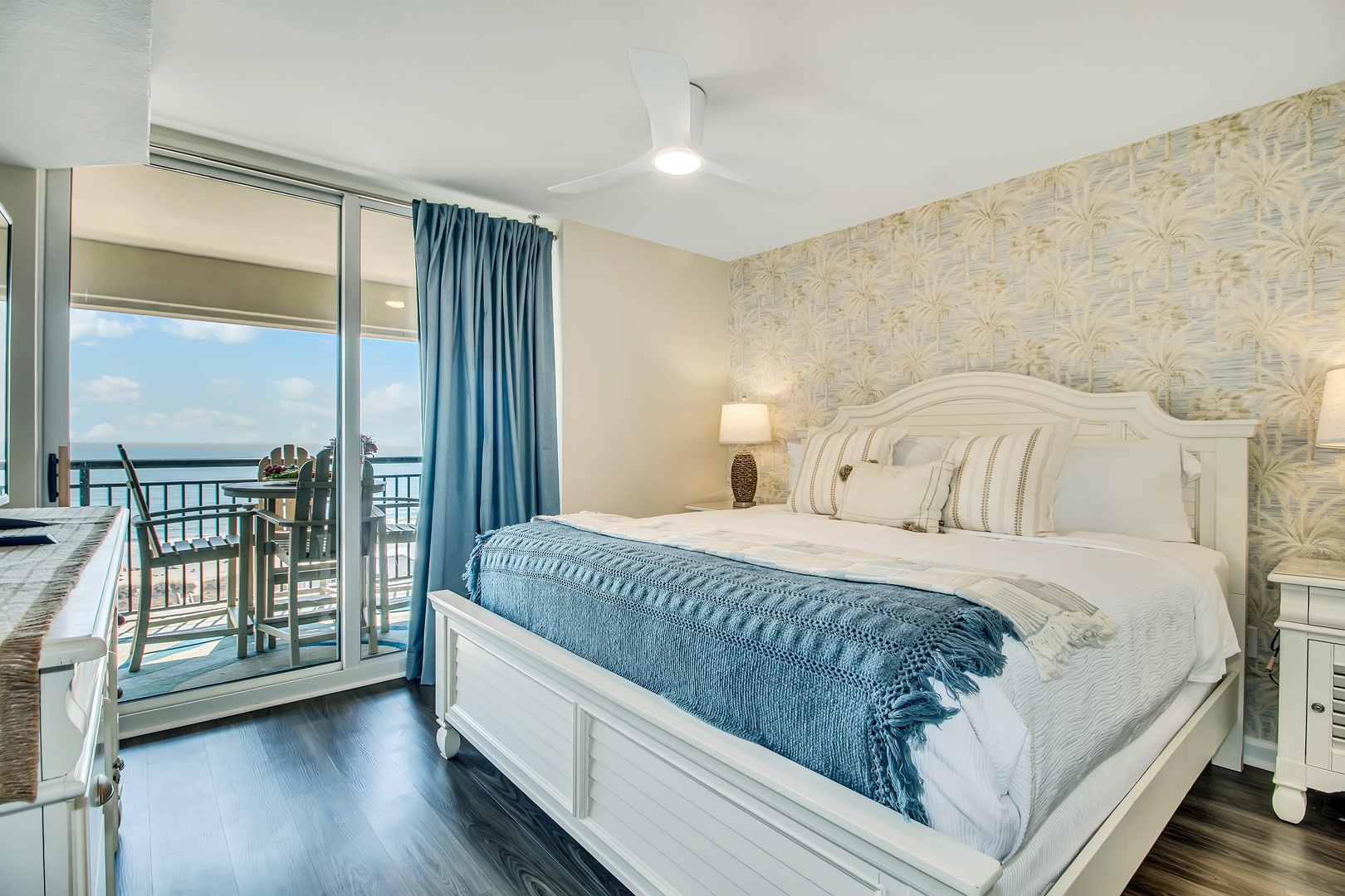 Drift off in this serene bedroom where coastal blues meet crisp whites, your private balcony offering stunning views.