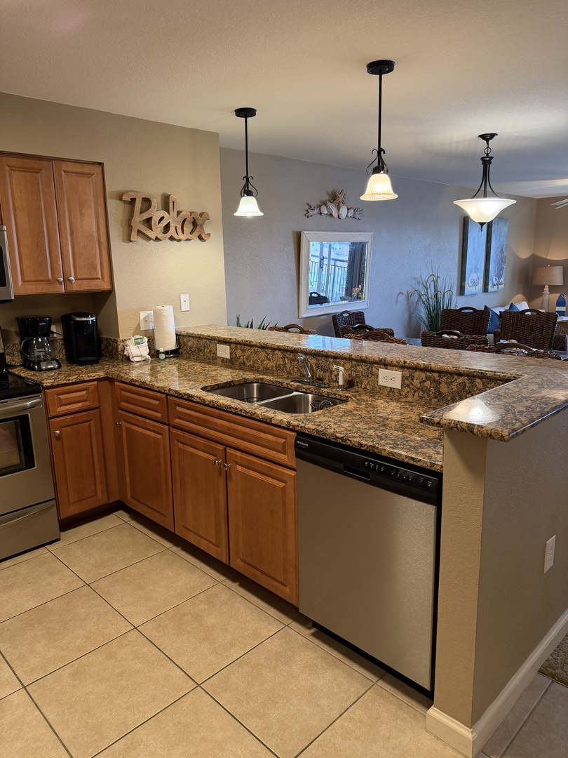 Your gourmet kitchen awaits with granite countertops, warm wood cabinets, and modern appliances perfect for creating memorable meals together.