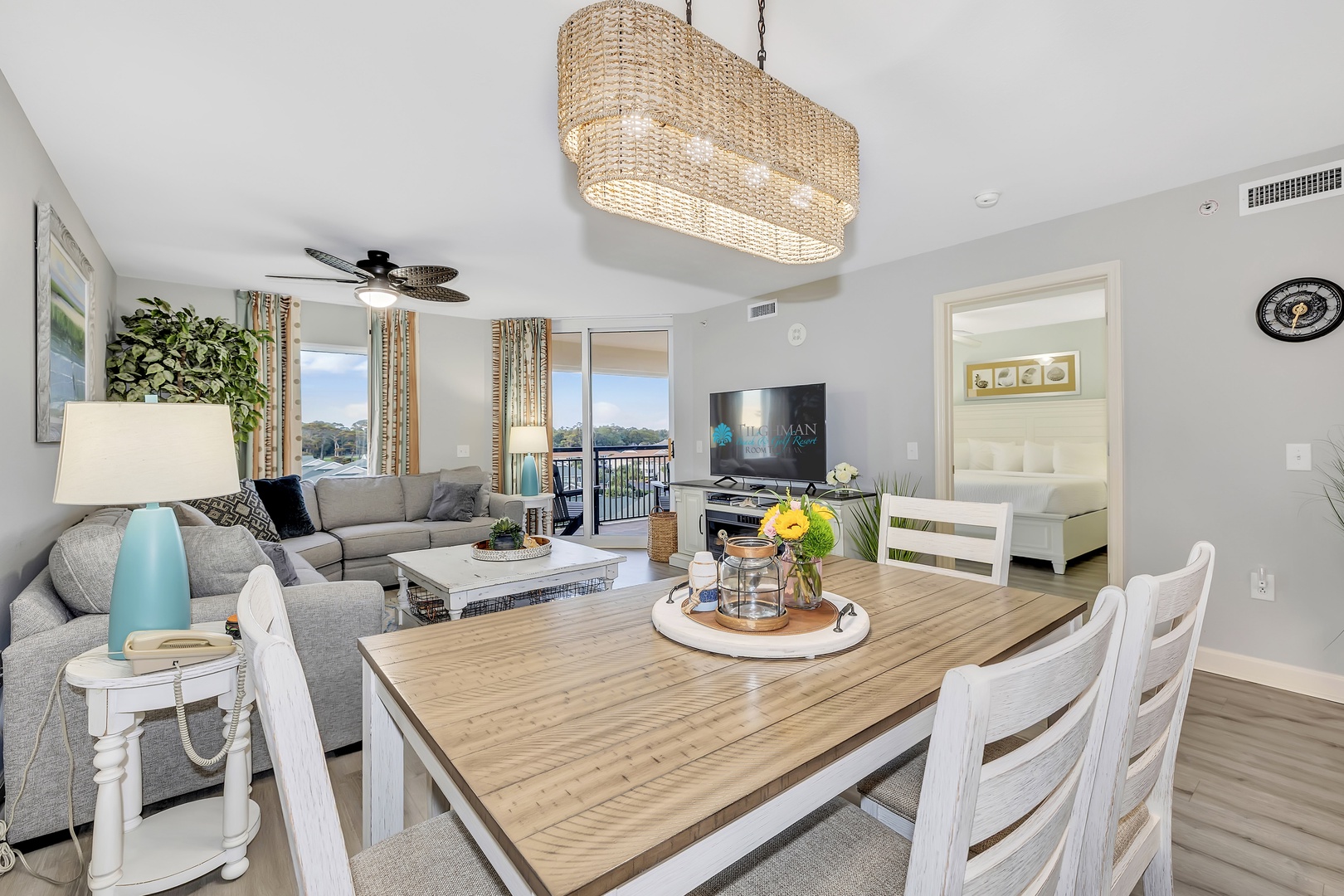 Settle in at your spacious dining table with room for the whole group, then relax on the plush sectional while gentle natural light flows through the balcony doors.