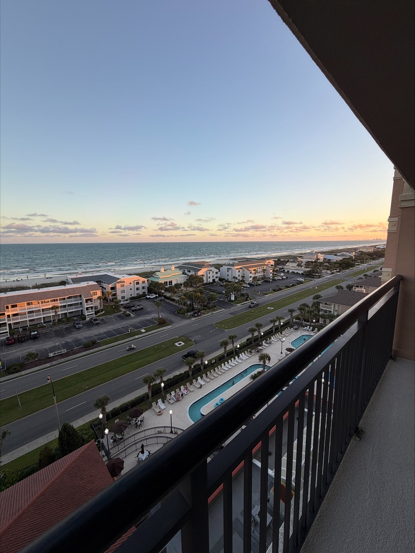 Sweeping ocean views greet you from your private balcony, where the beach stretches below and the horizon glows with golden light at sunset. This is your tranquil escape.