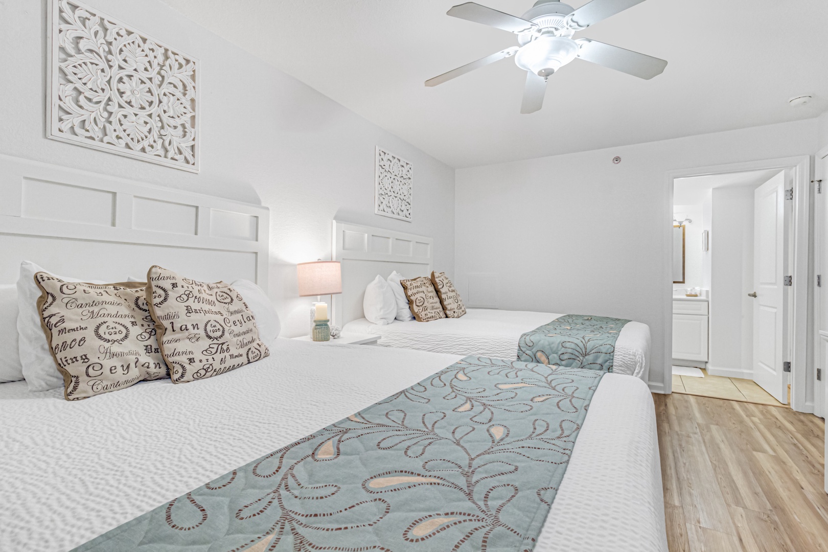 Drift into peaceful slumber in this elegant twin bedroom featuring plush white linens and coastal-inspired decor.