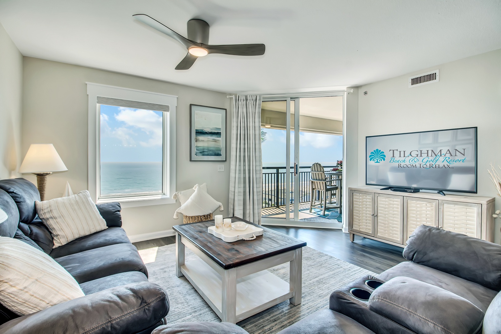 Sink into plush seating with stunning ocean views through floor-to-ceiling windows. Your coastal sanctuary features modern comfort and endless blue horizons.