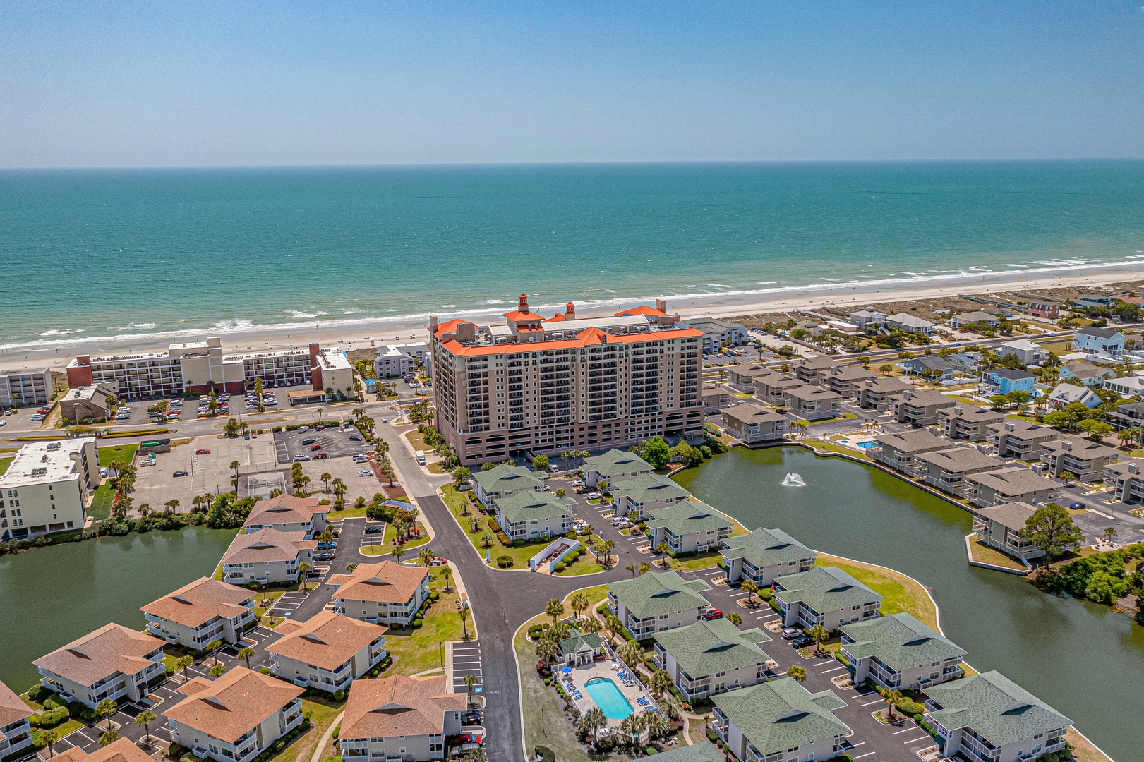 Beachfront resort community featuring vacation rentals along tranquil waterways, with ocean access and nearby coastal amenities just steps from pristine sandy shores.