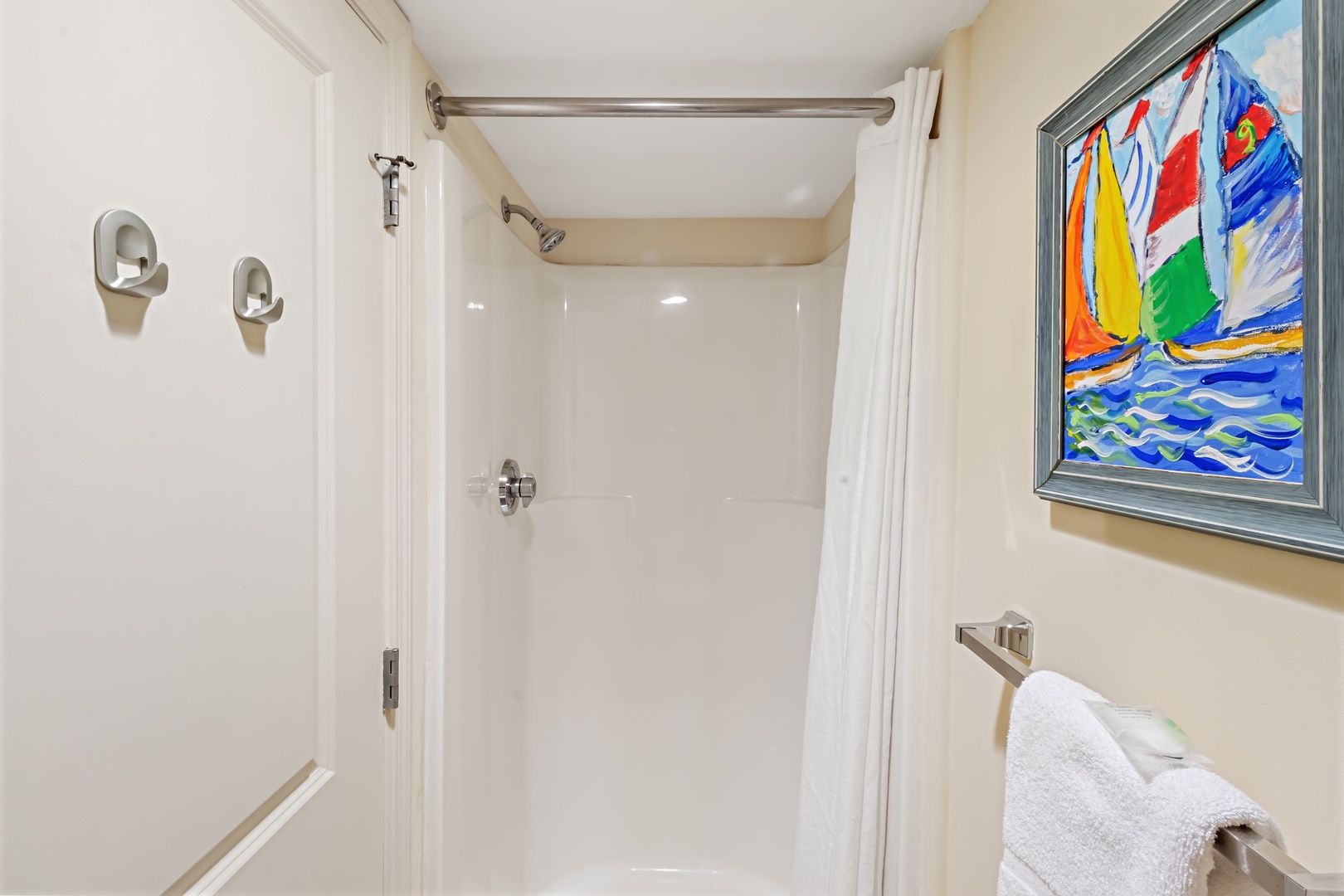 Refresh after beach adventures in your spotless private bathroom, complete with fluffy towels and cheerful sailboat artwork.