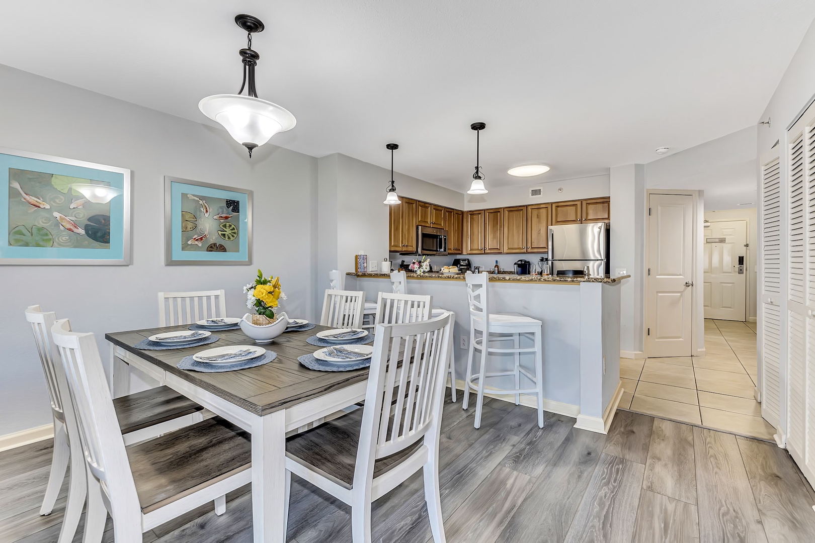 Gather around this welcoming dining space where meals become memories, with warm wood tones and coastal charm setting the scene for your vacation mornings and evenings together.