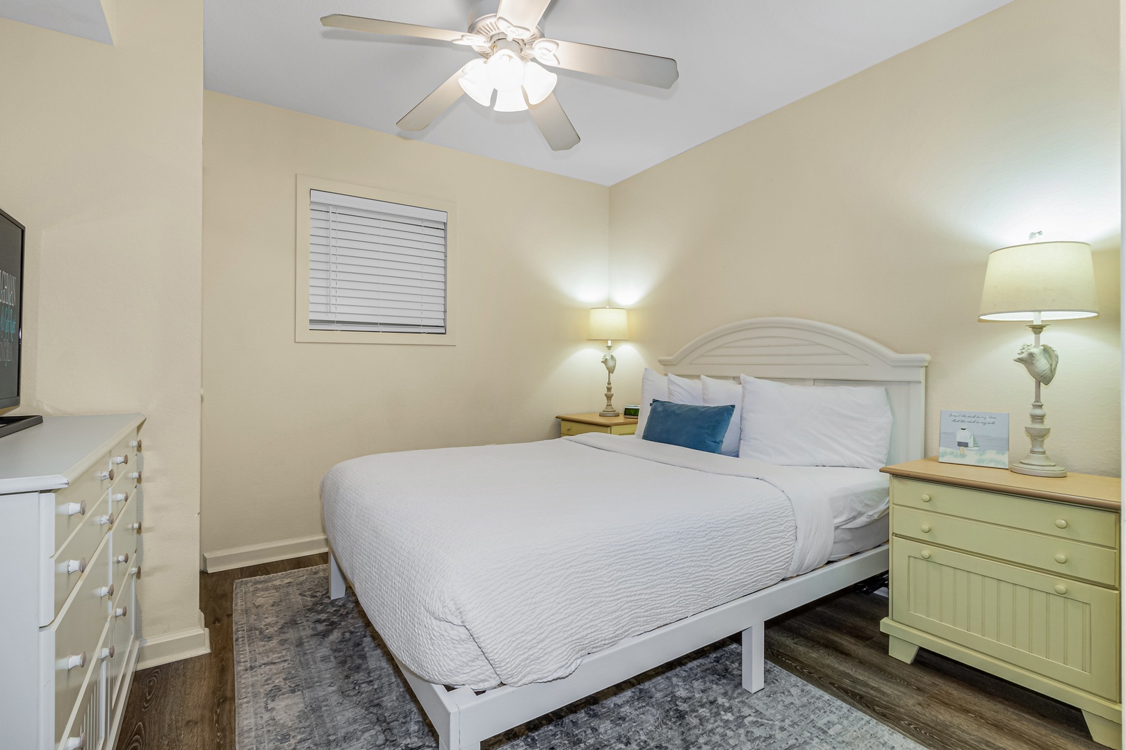 Drift off to sleep in your cozy bedroom with soft linens, gentle lighting, and a ceiling fan for perfect comfort.