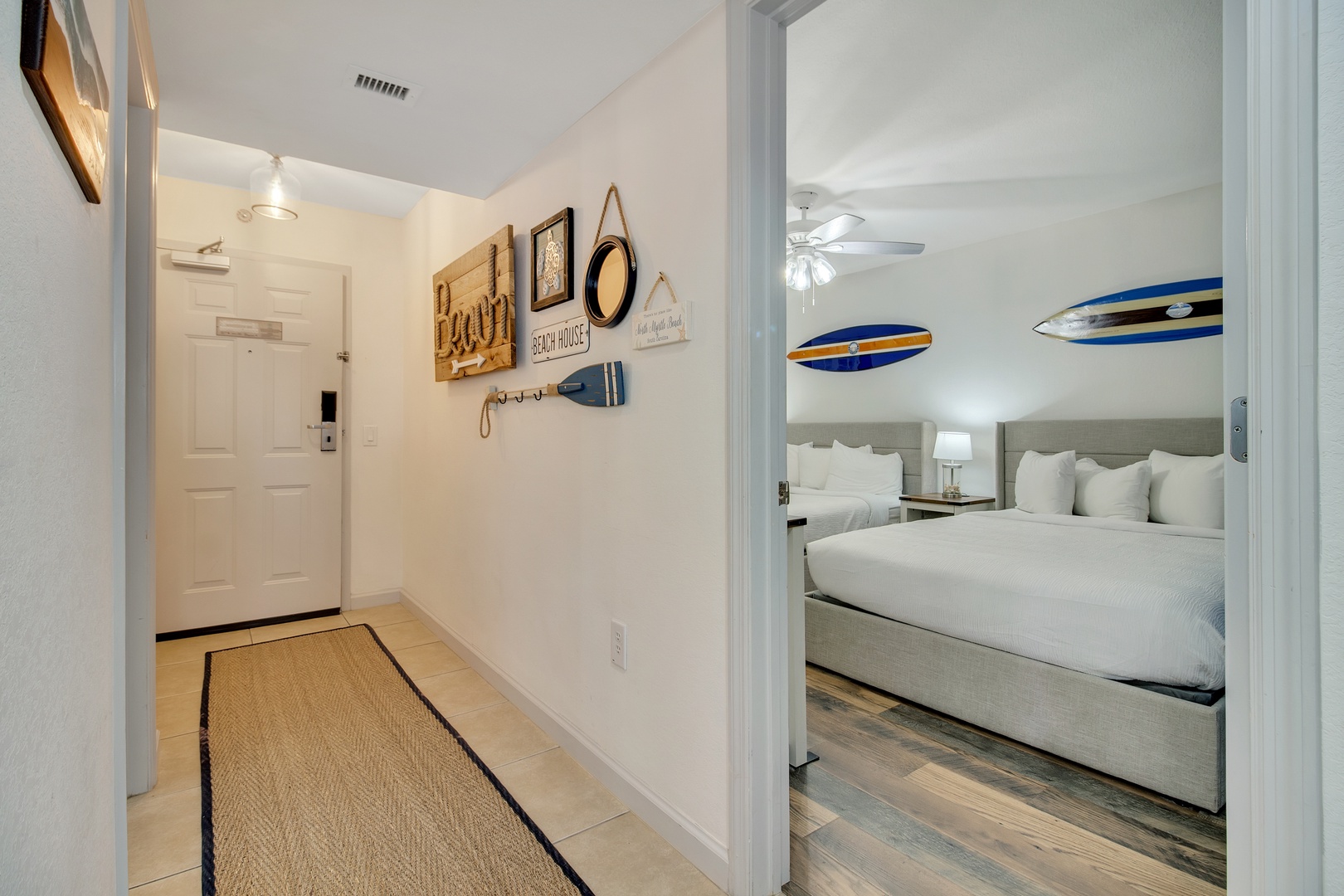 Step into your coastal retreat where beach-themed decor and comfortable beds await your arrival.