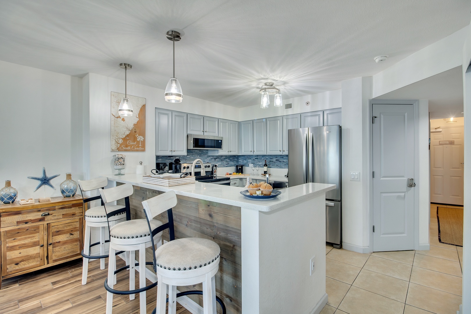 Your fully equipped kitchen awaits with coastal touches, granite counters, and everything you need to create memorable meals during your stay.