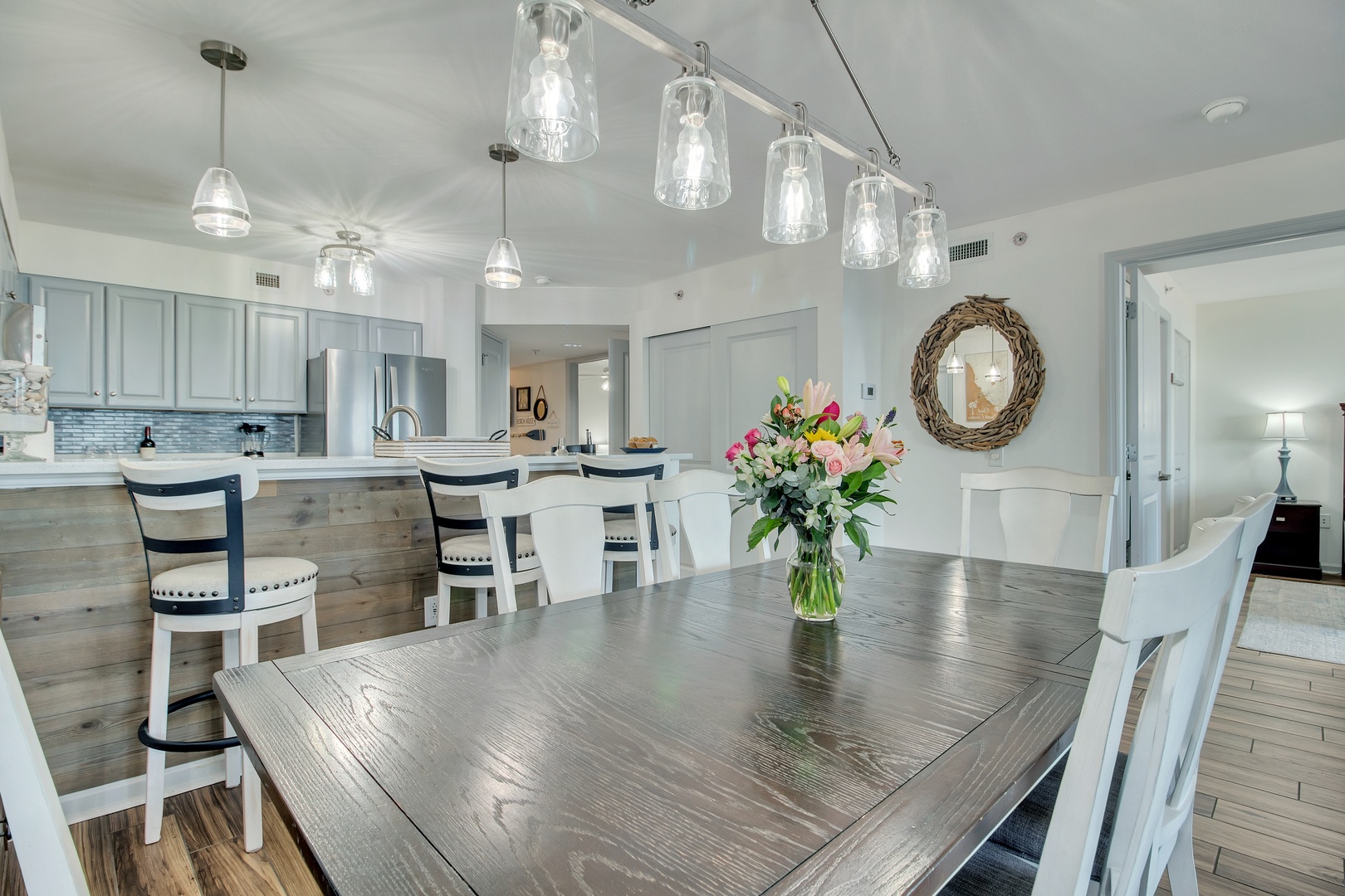 Gather around this elegant dining table where fresh flowers and stunning lighting create the perfect setting for memorable meals with loved ones.