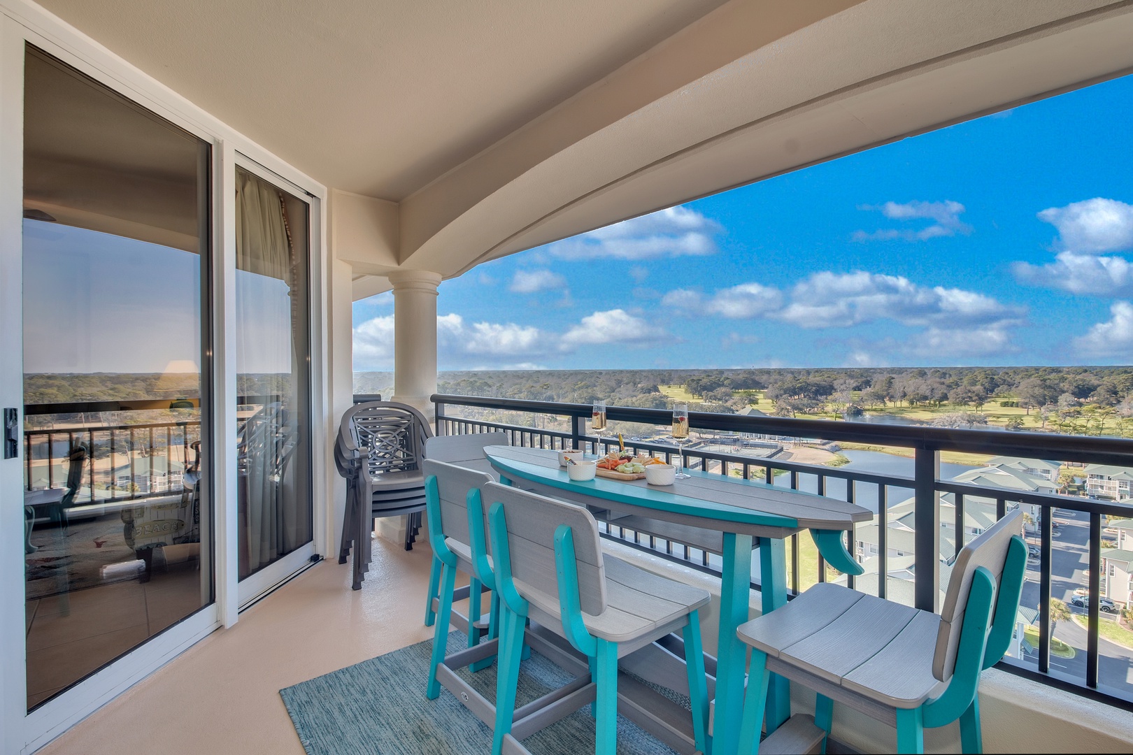 Sip your morning coffee at this bright balcony table while taking in sweeping views of the landscape below.