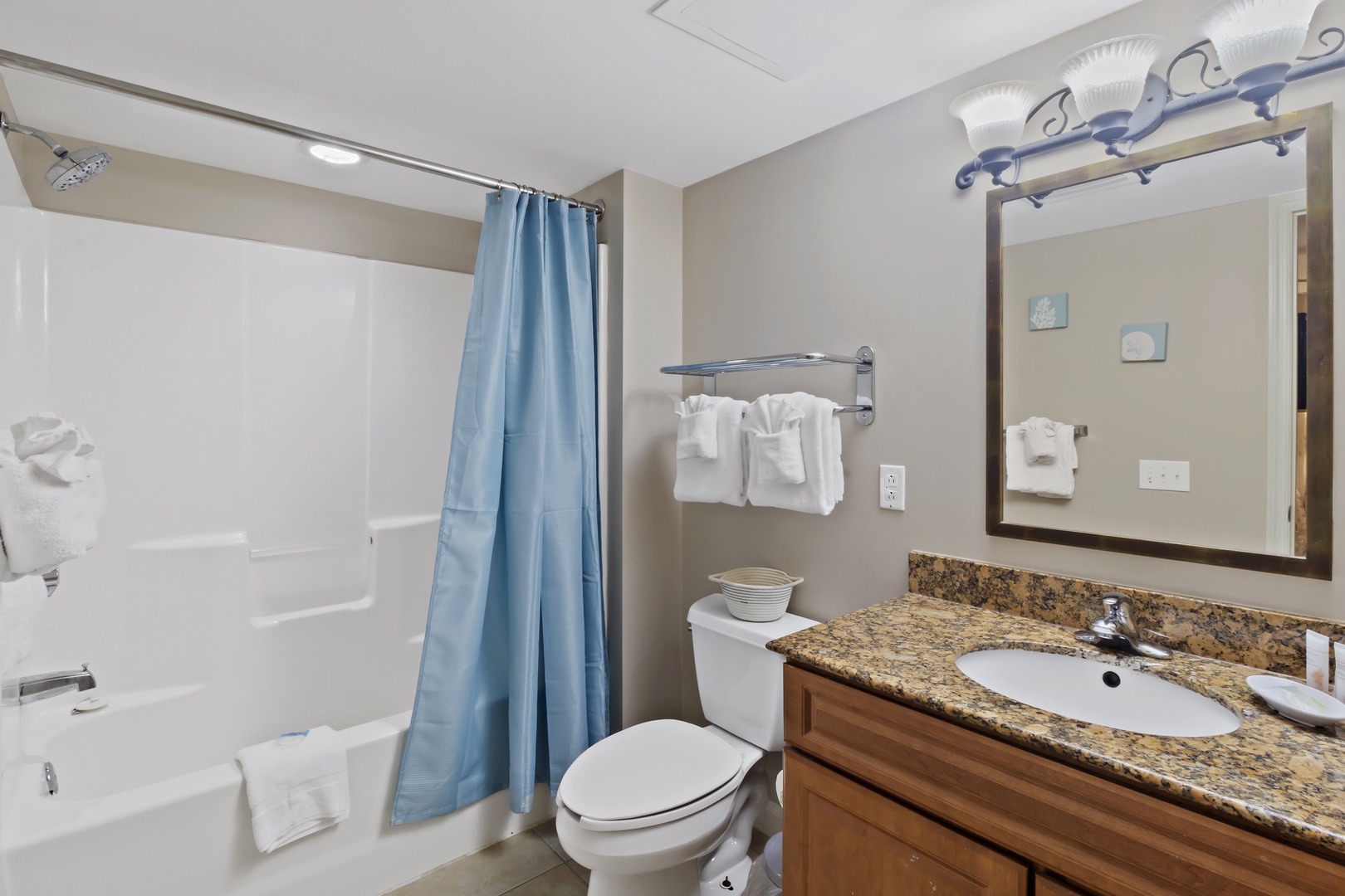 Your private bathroom features a spacious tub-shower combo, granite countertops, and fresh towels waiting for your arrival.