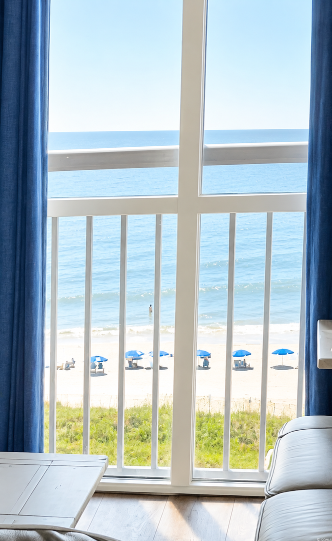 Breathtaking ocean views greet you from your private balcony. Watch the waves roll in, feel the sea breeze, and unwind as beach umbrellas dot the sandy shore below.