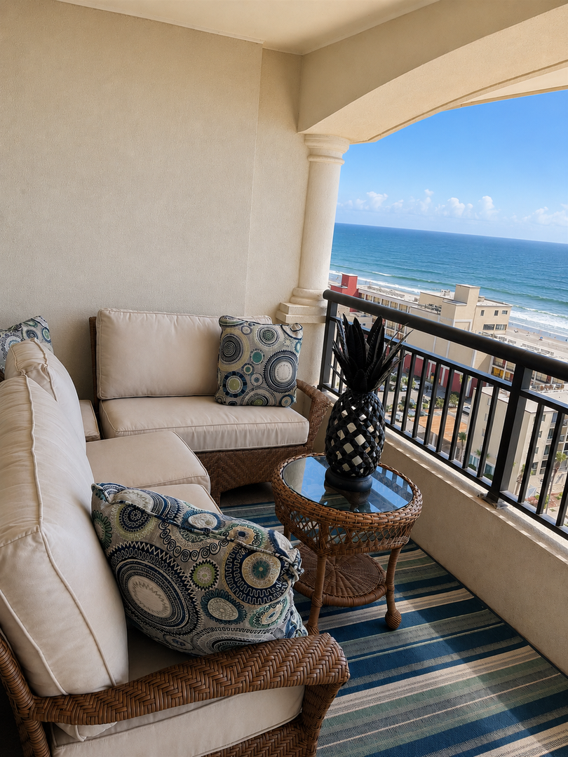The private balcony offers stunning ocean views and is perfect for morning coffee or evening cocktails. Relax in comfortable wicker seating and breathe in the salty sea breeze.