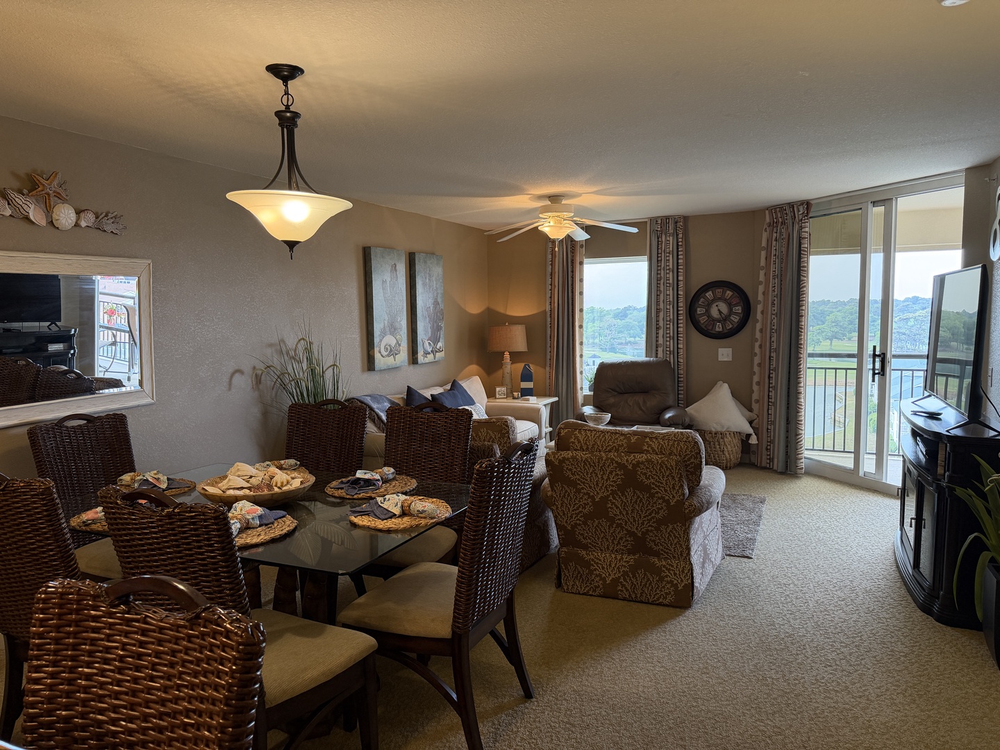 Relax in your spacious lakefront living room with panoramic water views through floor-to-ceiling windows. Unwind on plush seating while enjoying the serene lake scenery.