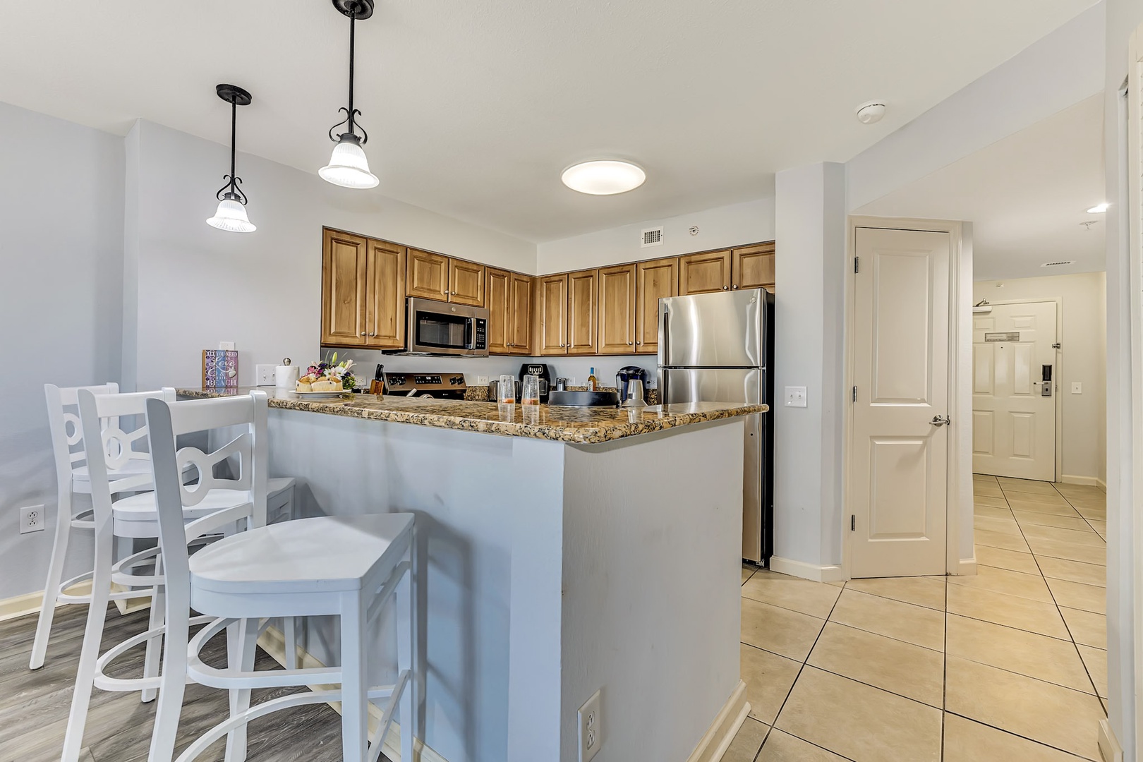 Your fully equipped kitchen with granite countertops and breakfast bar invites effortless meal prep and casual dining. Bright, spacious, and stocked with everything you need for a comfortable stay.