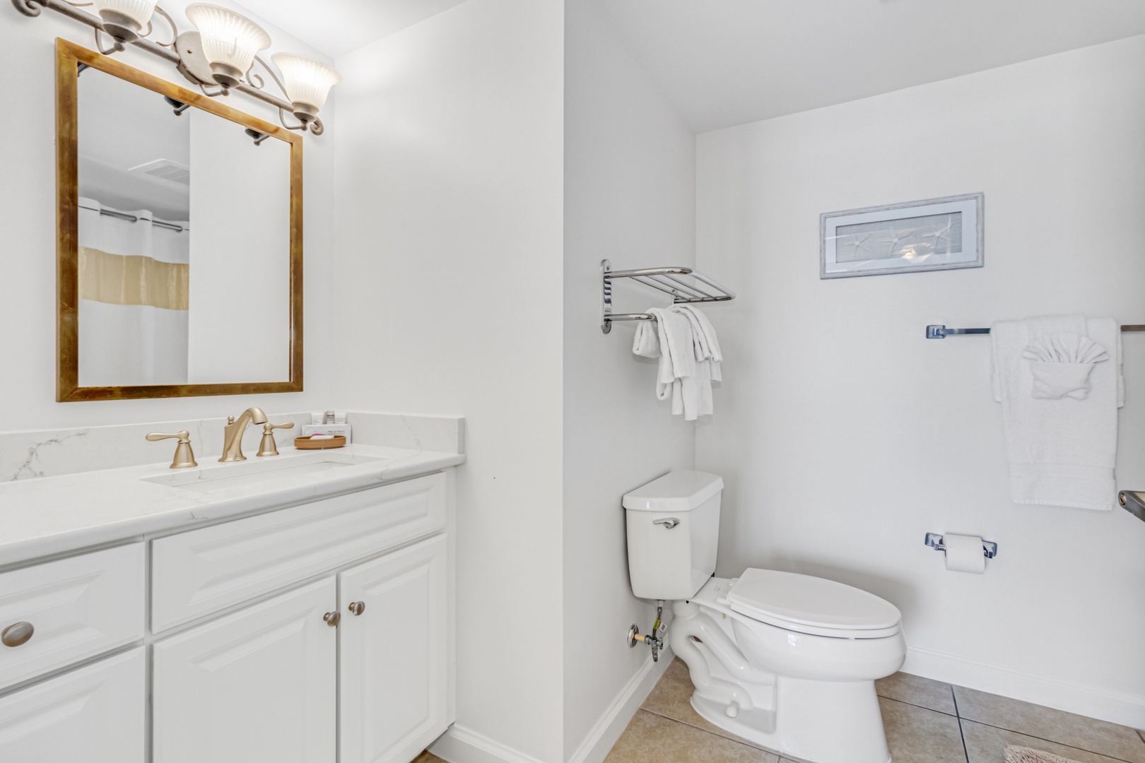 Refresh in your bright, clean bathroom with marble countertops, golden fixtures, and a relaxing tub perfect for unwinding after your adventures.