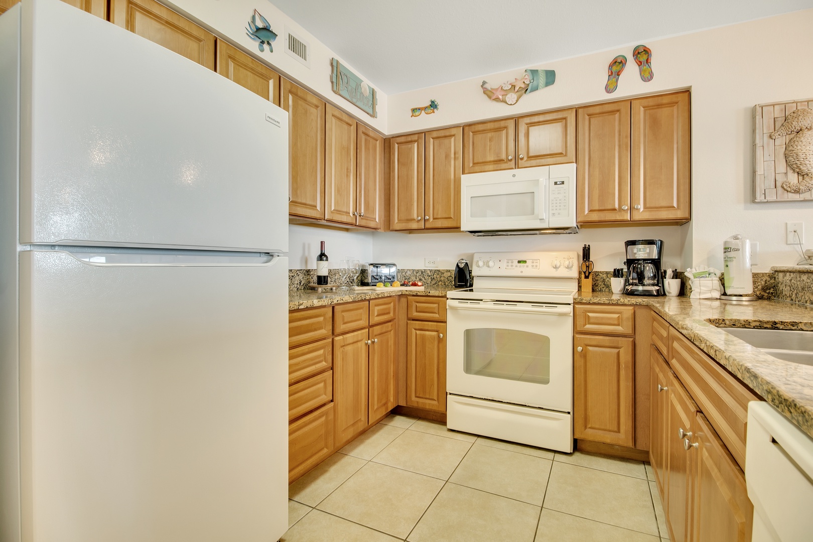Your fully equipped kitchen awaits with warm wood cabinets, granite countertops, and everything you need to prepare delicious meals during your stay.