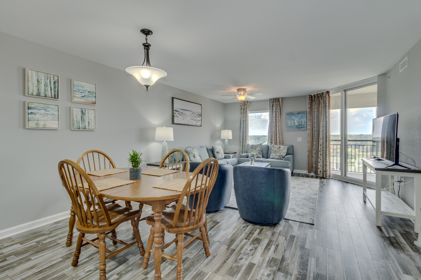 Your bright, open-concept living space seamlessly blends dining and relaxation areas, with floor-to-ceiling windows framing beautiful outdoor views.