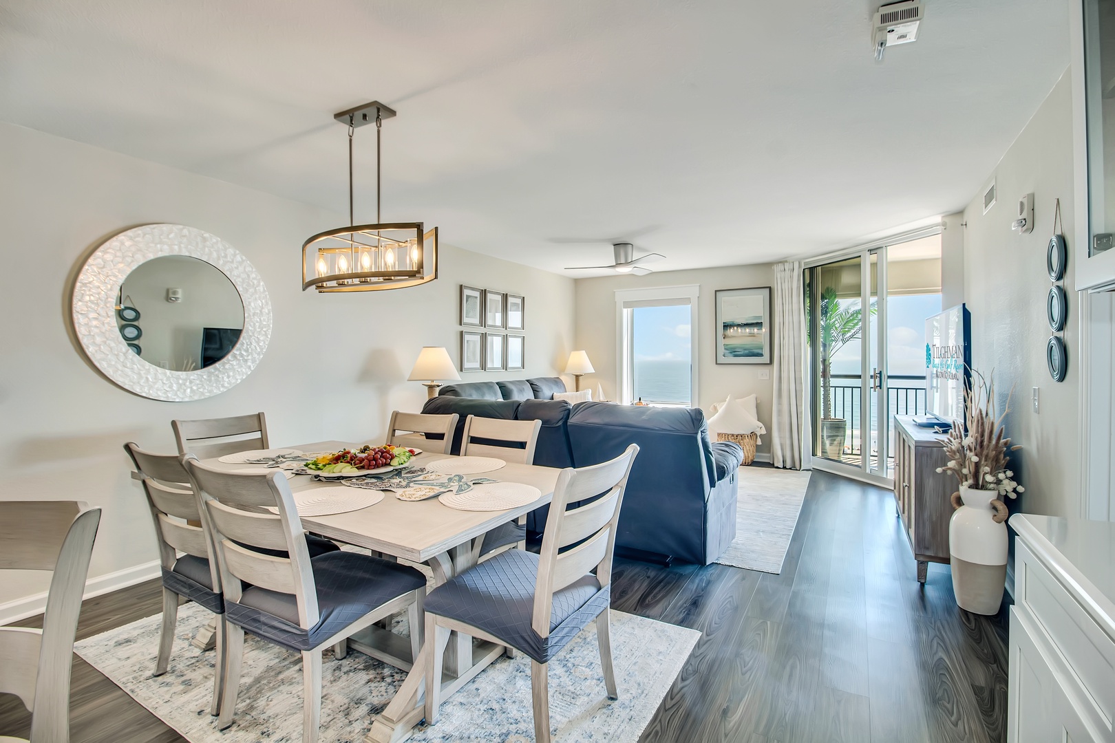 Gather around your elegant dining table while natural light fills this beautifully appointed open-concept space, perfect for memorable meals together.