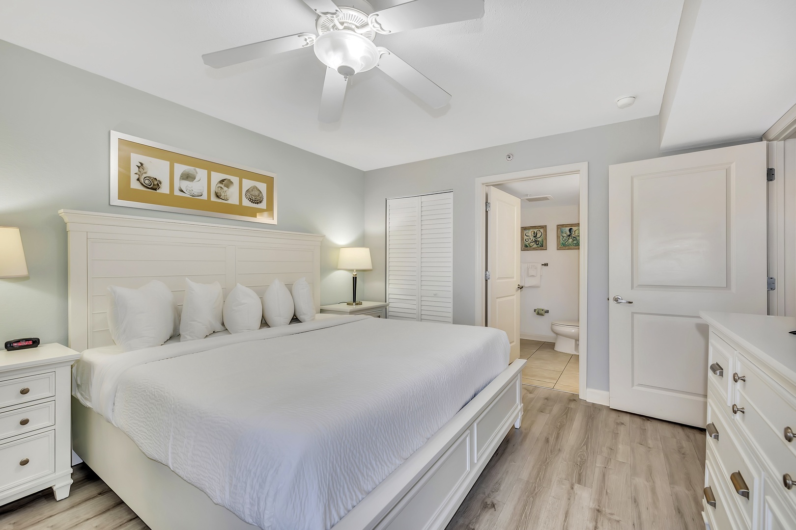 Relax into soft white linens and coastal charm in your serene bedroom retreat, with a private bathroom just steps away and ample storage for all your belongings.