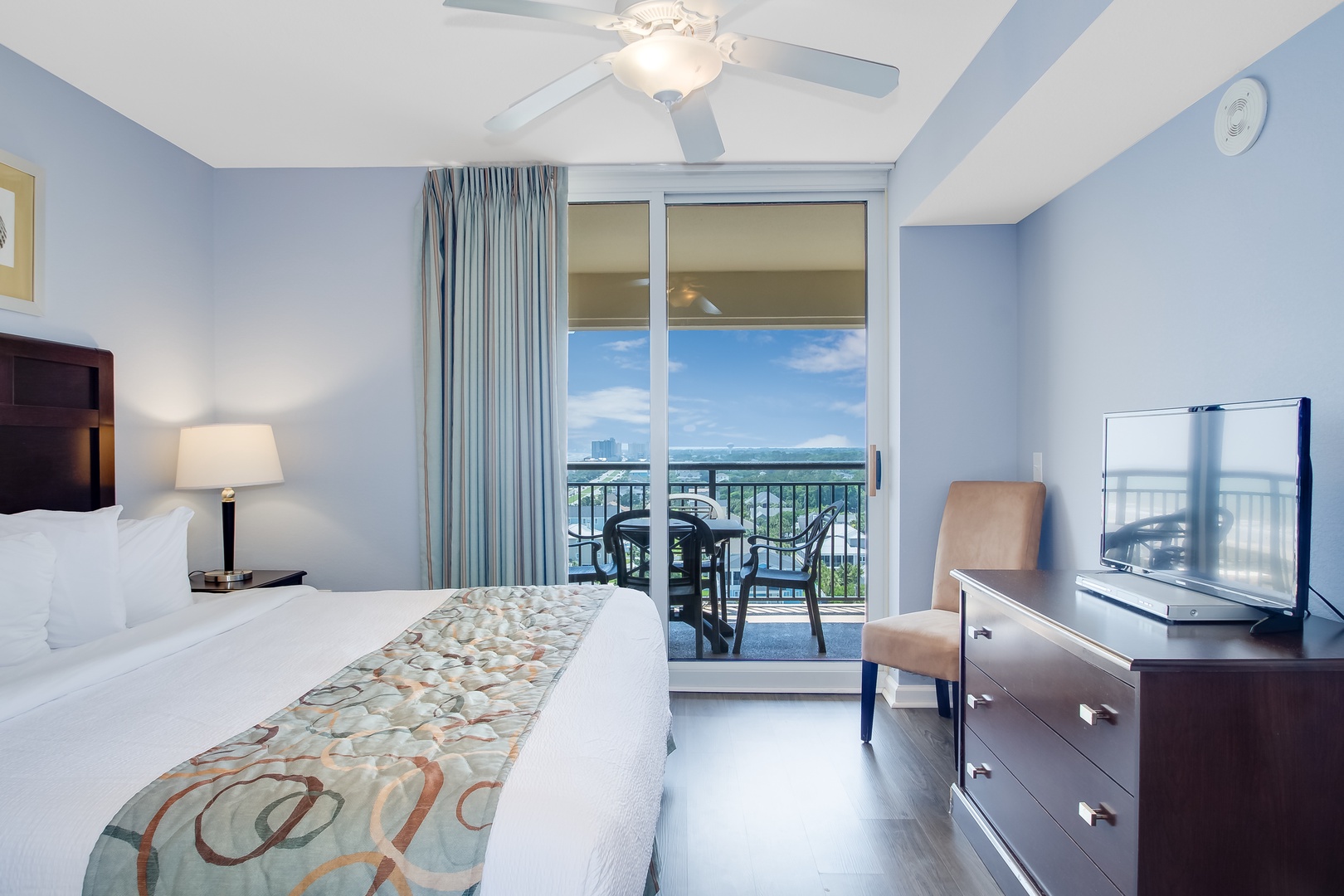 Relax in your bright bedroom with ocean views from your private balcony, complete with comfortable seating and modern amenities.