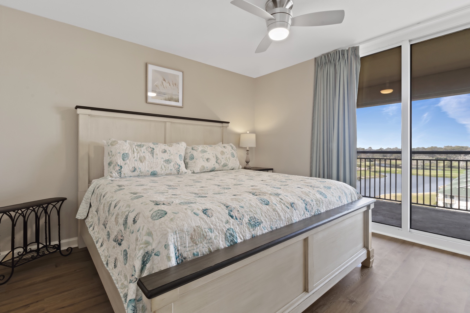 Drift off in your serene bedroom sanctuary with peaceful views and gentle ceiling fan breezes creating the perfect sleep environment.