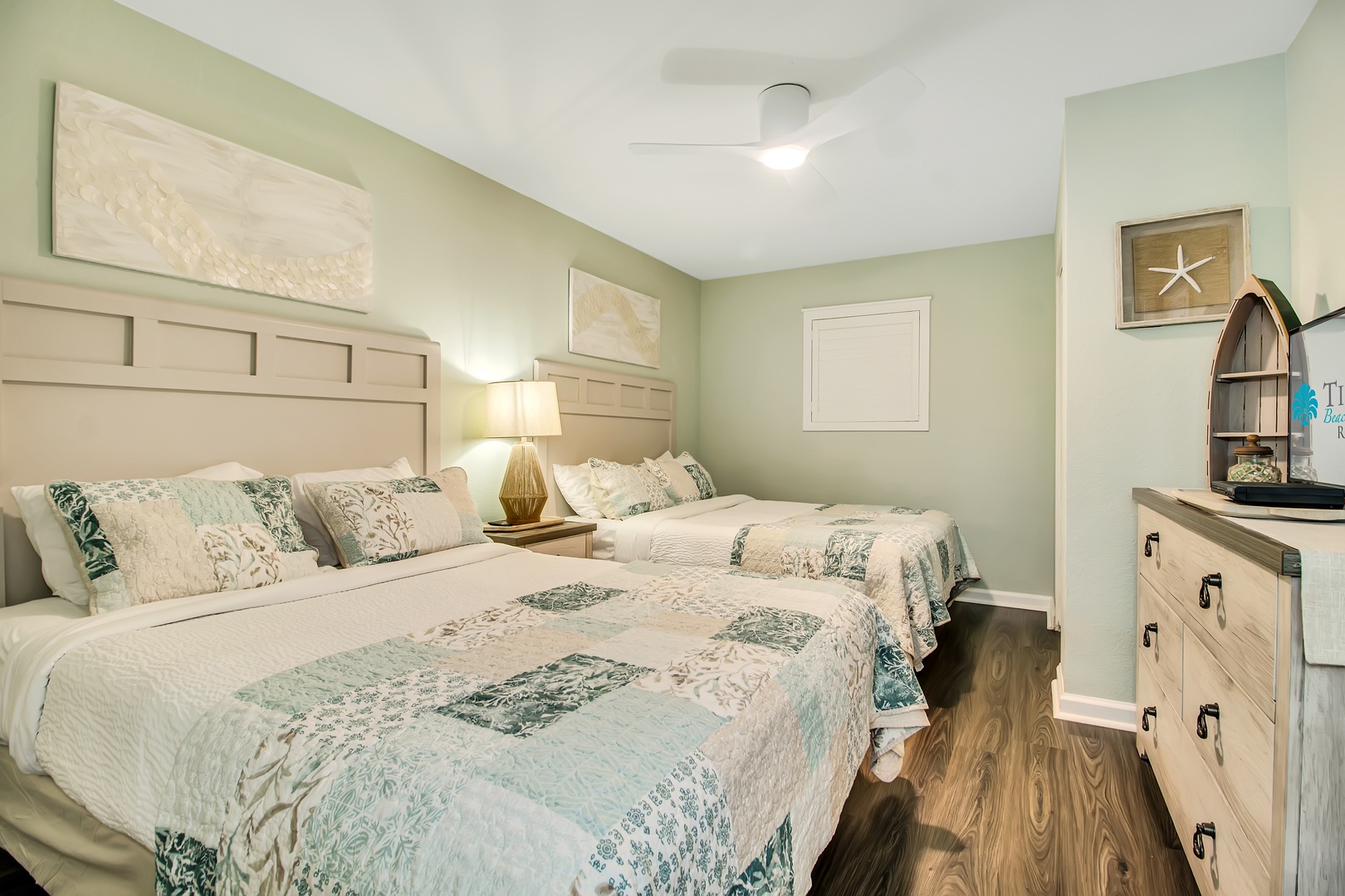 Drift off peacefully in your coastal-themed twin bedroom, where soft sea-green quilts and warm nautical touches create the perfect seaside sanctuary.