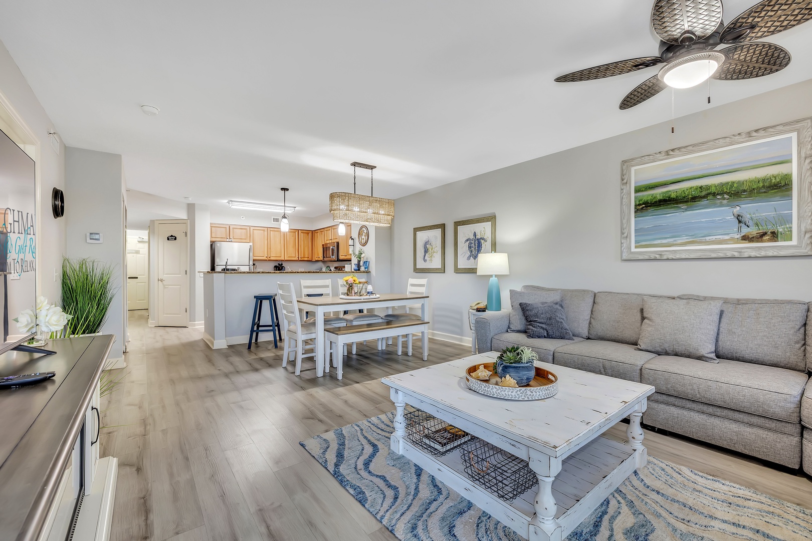 Unwind in your coastal retreat, where soft neutrals and breezy décor welcome you home—settle into the plush sofa or gather around the dining table for meals and memories.