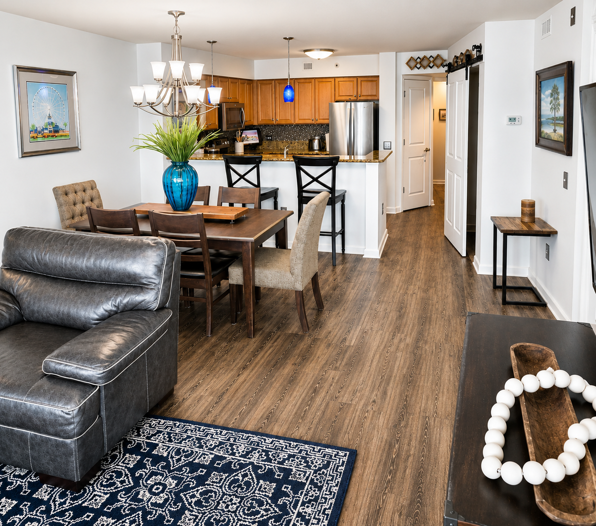Settle into your inviting open-concept retreat, where warm wood floors flow between a cozy living room, dining space, and fully-equipped kitchen—perfect for unwinding or gathering after exploring the area.